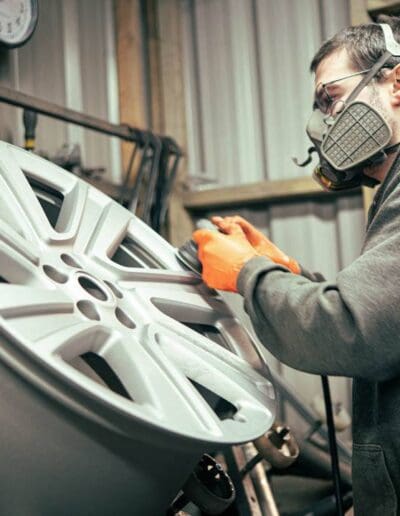 SKS Coating staff adding a powder coat around an alloy wheel